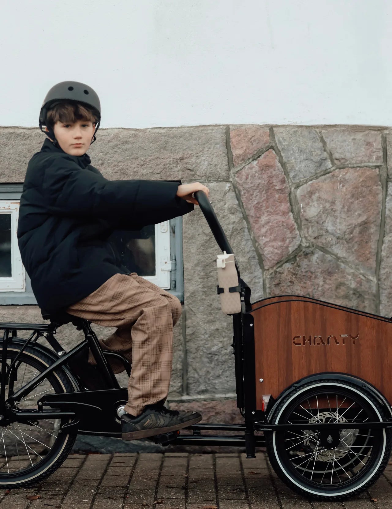 zeigt Junge auf Lastenrad